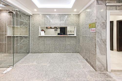 a bathroom with a shower with a glass door at Al Tamayoz Al Raqi - Bani Malik in Jeddah