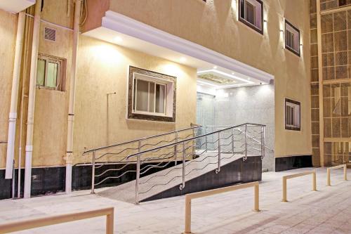 a staircase in a building with a metal railing at Al Tamayoz Al Raqi - Bani Malik in Jeddah