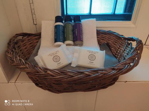 a basket filled with toiletries in a bathroom at Happy Homestay in Jaipur