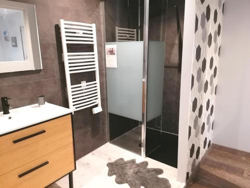 a bathroom with a shower and a sink at La résinière in Salles