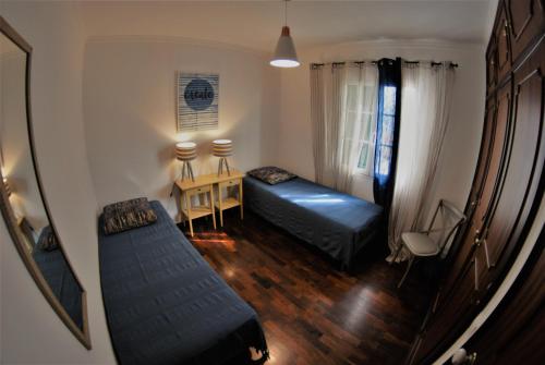 a small room with a bed and a table and a desk at Madeira Serenity Cottage in Funchal