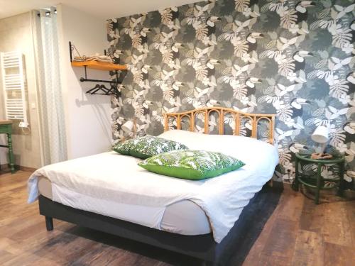 a bedroom with a bed with a floral wallpaper at La résinière in Salles
