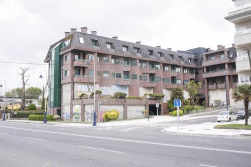 a large building on a city street with a road at Samil 2J in Vigo