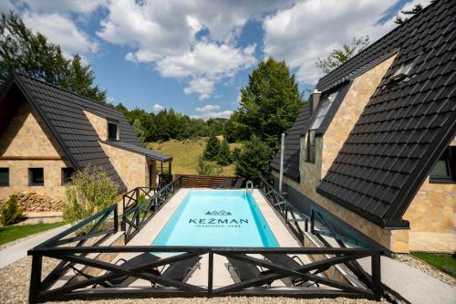 a swimming pool on the side of a house at Kežman Mountain Houses in Kopaonik