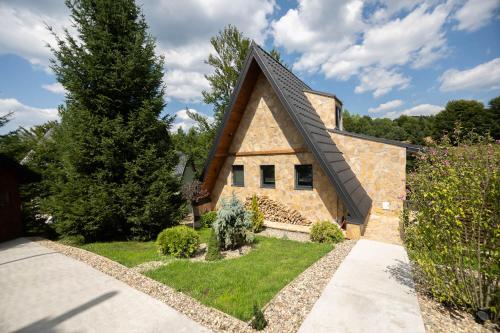 a stone house with a gambrel roof at Kežman Mountain Houses in Kopaonik