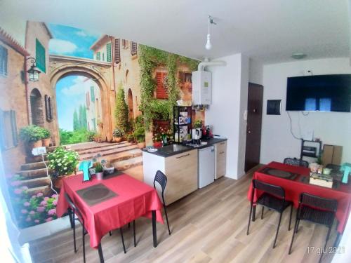a kitchen and dining room with a painting on the wall at Cornizzolo bed breakfast in Suello