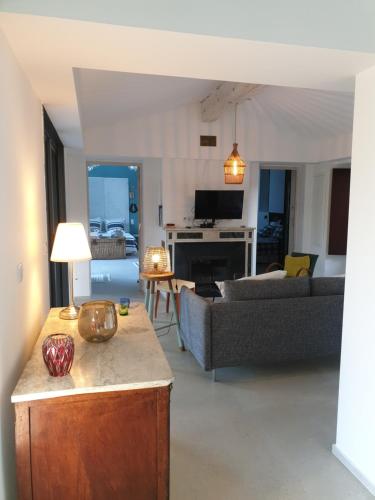 a living room with a couch and a table at Mas de la Petite Jeanne in Grimaud