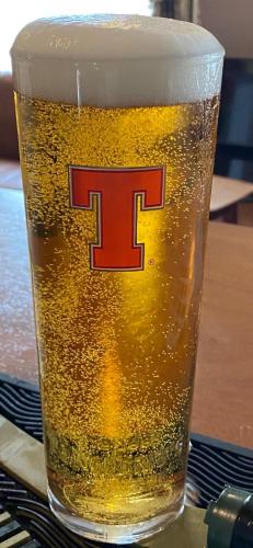 a glass of beer with the letter t on it at Queensberry arms hotel in Kirkconnel