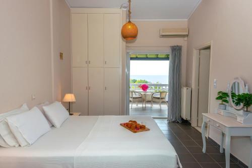 a bedroom with a large white bed and a table at Lns Vip Villas in Sivota