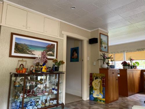 a room with a glass shelf with items on it at Green garden home in Whangarei