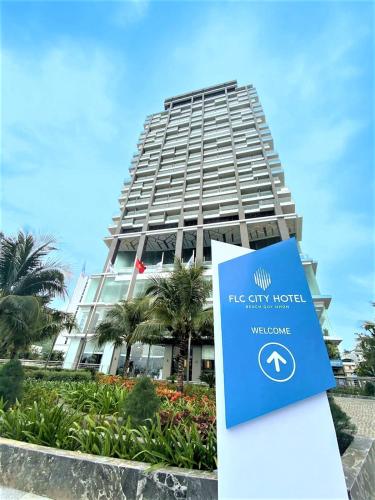 a building with a sign in front of it at FLC City Hotel Beach Quy Nhon in Quy Nhon