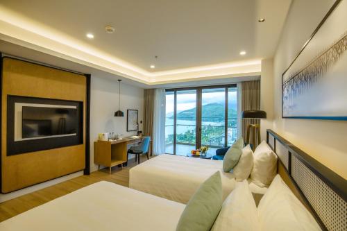 a hotel room with a bed and a desk at FLC City Hotel Beach Quy Nhon in Quy Nhon