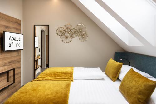 a bedroom with a bed with a yellow blanket at Apart of me Klagenfurt in Klagenfurt