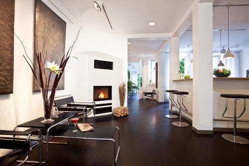a living room filled with furniture and a fire place at Aussen Alster Hotel in Hamburg