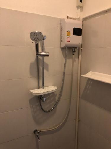 a shower in a bathroom with a hair dryer at Daisy's 2 bedroom family home for up to 5 guests with garden & BBQ in Ko Samed