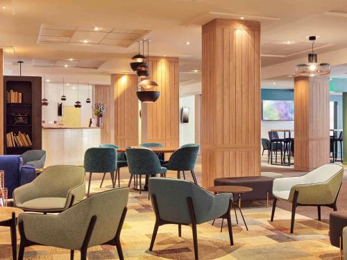 a waiting room with chairs and a table at Mercure Paris Porte d'Orleans in Montrouge