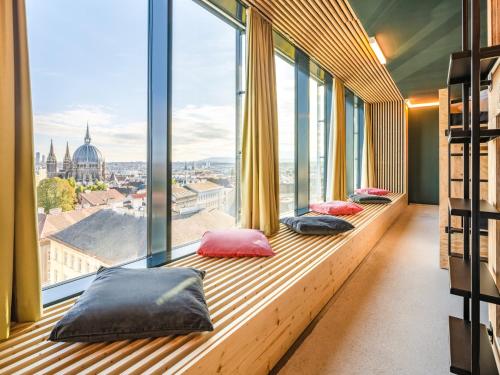 a row of windows in a building with pillows at JO&JOE Vienna in Vienna