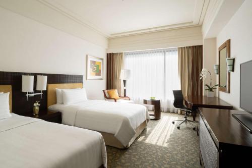 Un ou plusieurs lits dans un hébergement de l'établissement Edsa Shangri-La, Manila
