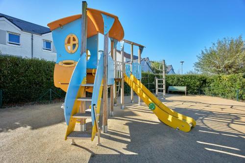 a row of slides at a playground at Pierre & Vacances Résidence Le Chant des Oiseaux in Courseulles-sur-Mer