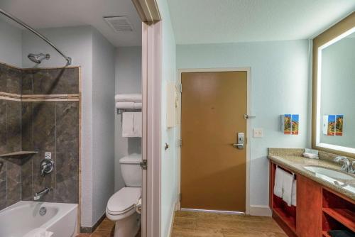 a bathroom with a toilet and a shower and a sink at Arroyo Pinion Hotel, an Ascend Collection Hotel in Sedona