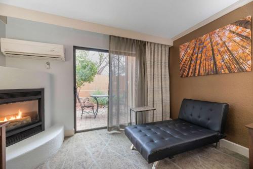 a living room with a couch and a fireplace at Arroyo Pinion Hotel, an Ascend Collection Hotel in Sedona