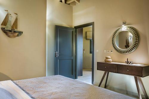 a bedroom with a bed and a mirror and a sink at Crystal Palace - Luce in Skala Kefalonias