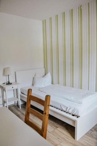 a bedroom with a bed and a table and a chair at Landgasthof Hotel Will in Neuenstein