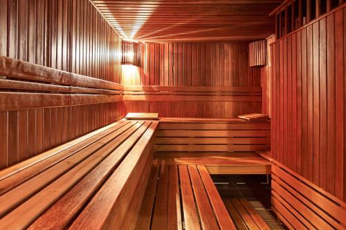 an empty wooden sauna with wooden benches in it at Radisson BLU Balmoral in Spa