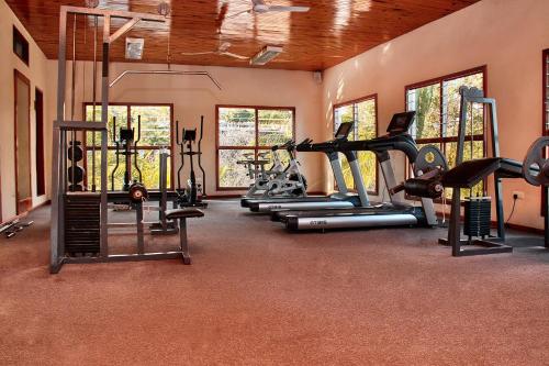 a gym with several treadmills and exercise bikes at Lake Kariba Inns in Siavonga