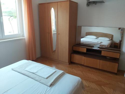 a bedroom with a bed and a large mirror at House Petar by sea in Trogir