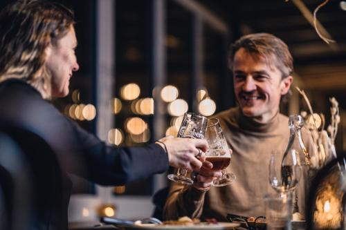 a man and a woman holding glasses of wine at Ocean Hotel in Falkenberg