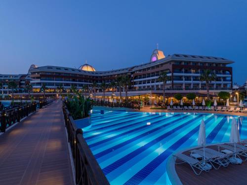 a view of a hotel pool at night at Tui Magic Life Jacaranda in Side