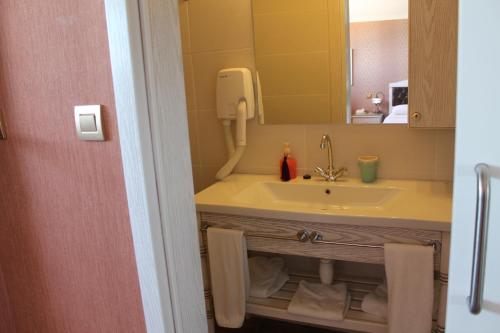 a bathroom with a sink and a mirror at Bella View Art Boutique Hotel in Kyrenia