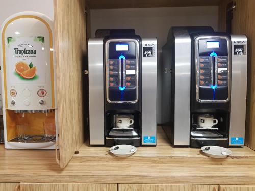 two machines sitting on top of a shelf at HOTEL KYRIAD ORANGE Centre Ville - A7-A9 - 3 Etoiles - HOTEL DES PRINCES - Provence Alpes Côte d'Azur - France in Orange