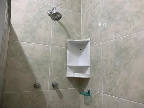 a shower with a shower head in a bathroom at Pousada e Restaurante Tio Paulo in Teresópolis