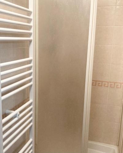 a walk in closet with white shelves and a shower at B&B Mela in Rogiano Gravina