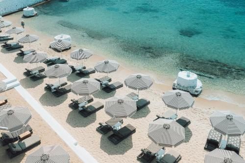 an overhead view of a beach with chairs and umbrellas at Mykonos Blanc - Preferred Hotels & Resorts in Ornos