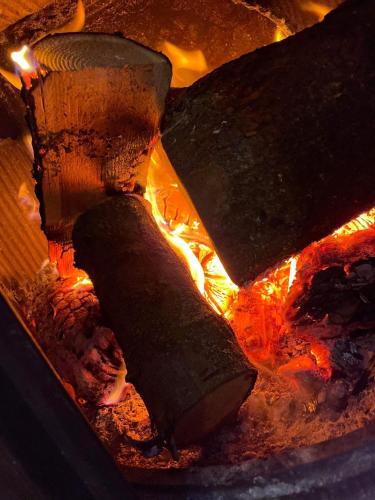 a close up of a fire in an oven at Crosskeys Inn Guest Rooms in Wye Valley in Hereford