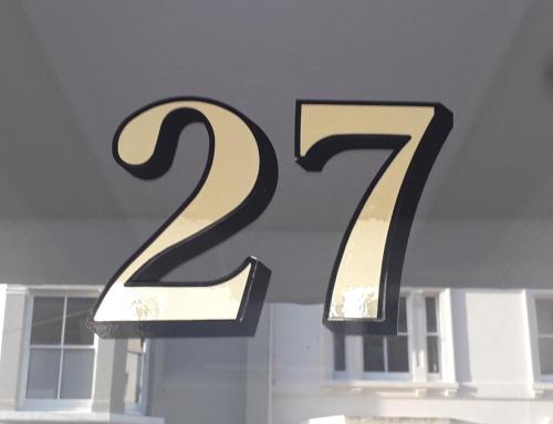 a large black and gold number in a window at Stay@27 in Brighton & Hove