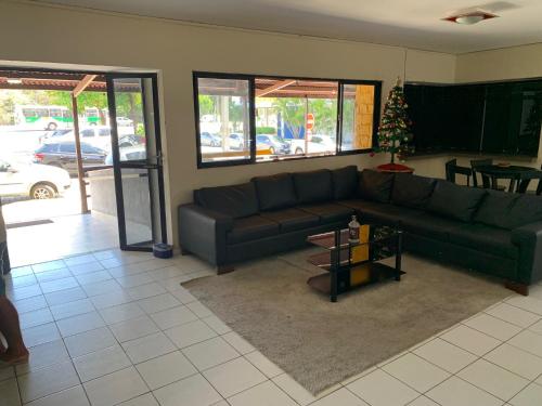 a living room with a couch and a christmas tree at CP Hotel Economic in Natal