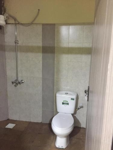 a bathroom with a white toilet in a stall at Bubbles Lodge Kinangop in South Kinangop