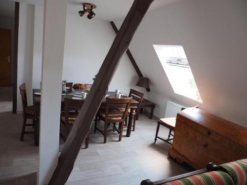 a dining room with a table and a table and chairs at Landblick in Nahrendorf