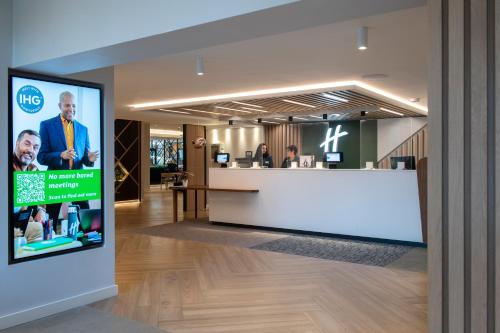 a lobby of a hospital with a tv in the foreground at Holiday Inn London-Shepperton by IHG in Shepperton