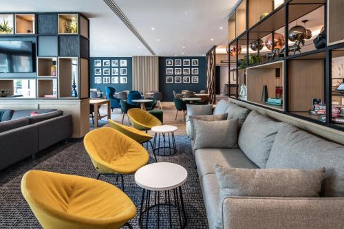 a living room with a couch and chairs and tables at Holiday Inn London-Shepperton by IHG in Shepperton