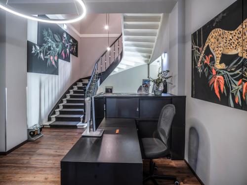 ein Heimbüro mit einem Schreibtisch und einer Treppe in der Unterkunft acor Boutique Hotel in Heidelberg