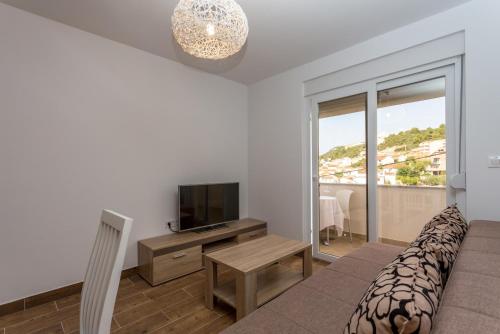 a living room with a couch and a television at Holiday Home in Komarna