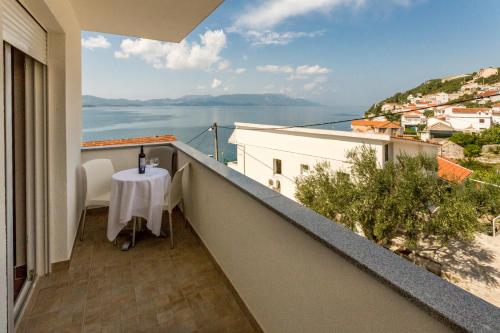 a balcony with a table and a view of the water at Holiday Home in Komarna
