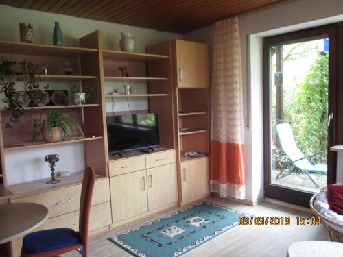 a living room with a entertainment center with a television at Ferienwohnung Troglauer in Letzau