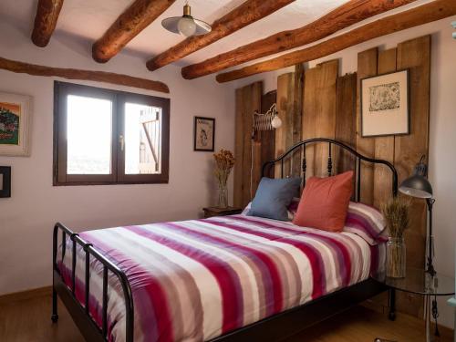 a bedroom with a bed and a window at Casa Cosialls in Benabarre