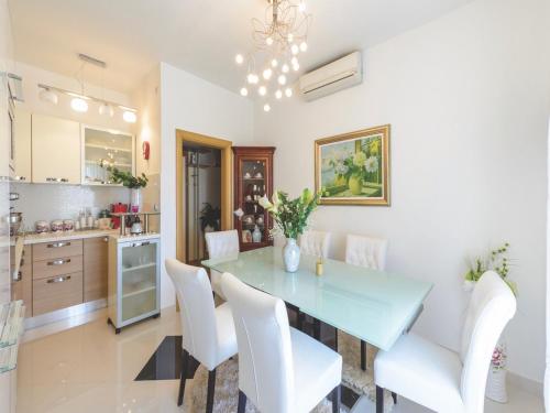 a kitchen and dining room with a blue table and white chairs at Apartment Viva la Vita in Cavtat